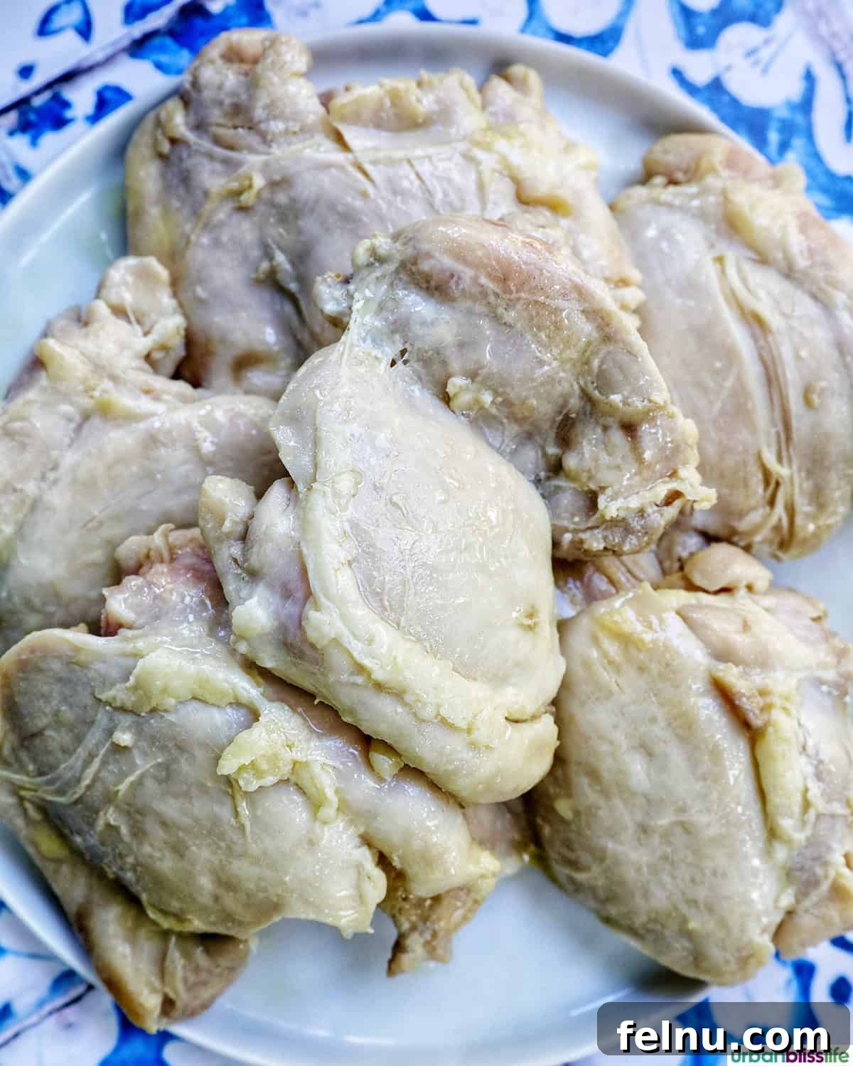 Rich Brandy Peppercorn Chicken 8 Golden-brown chicken thighs removed from the pan, resting on a plate while the sauce is prepared.