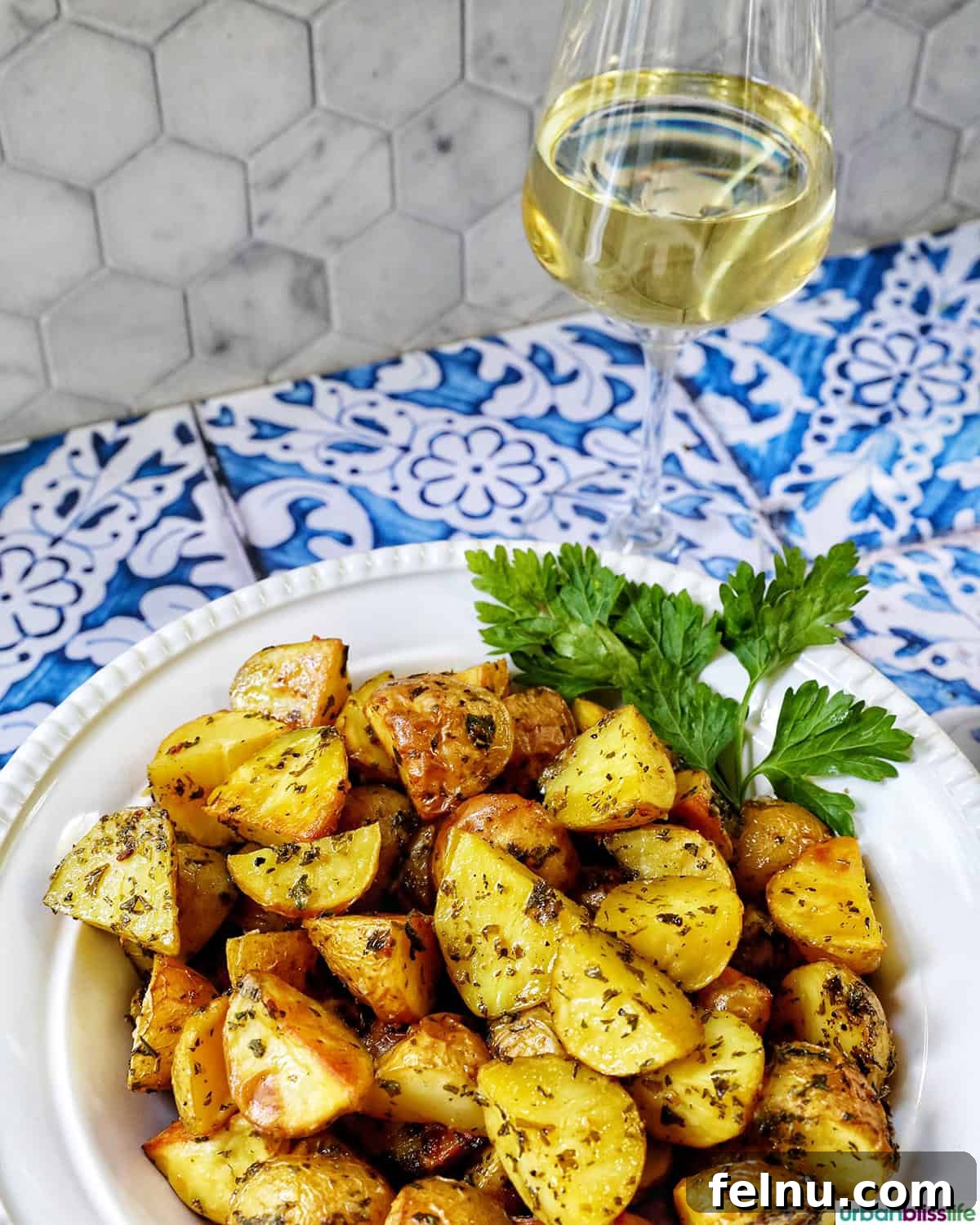 Herb-Infused Potato Delights 11 Herby potatoes paired with a glass of crisp white wine.