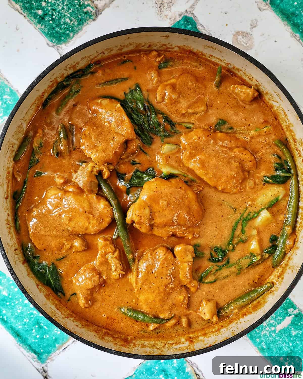 Rich Filipino Peanut Chicken 17 The finished Filipino chicken kare kare, garnished and ready to serve, in a large pan.