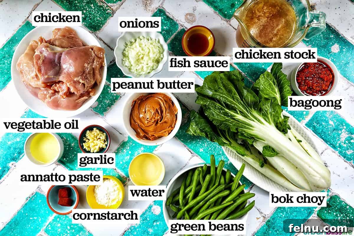 Rich Filipino Peanut Chicken 5 A flat lay of fresh ingredients laid out for making chicken kare kare.