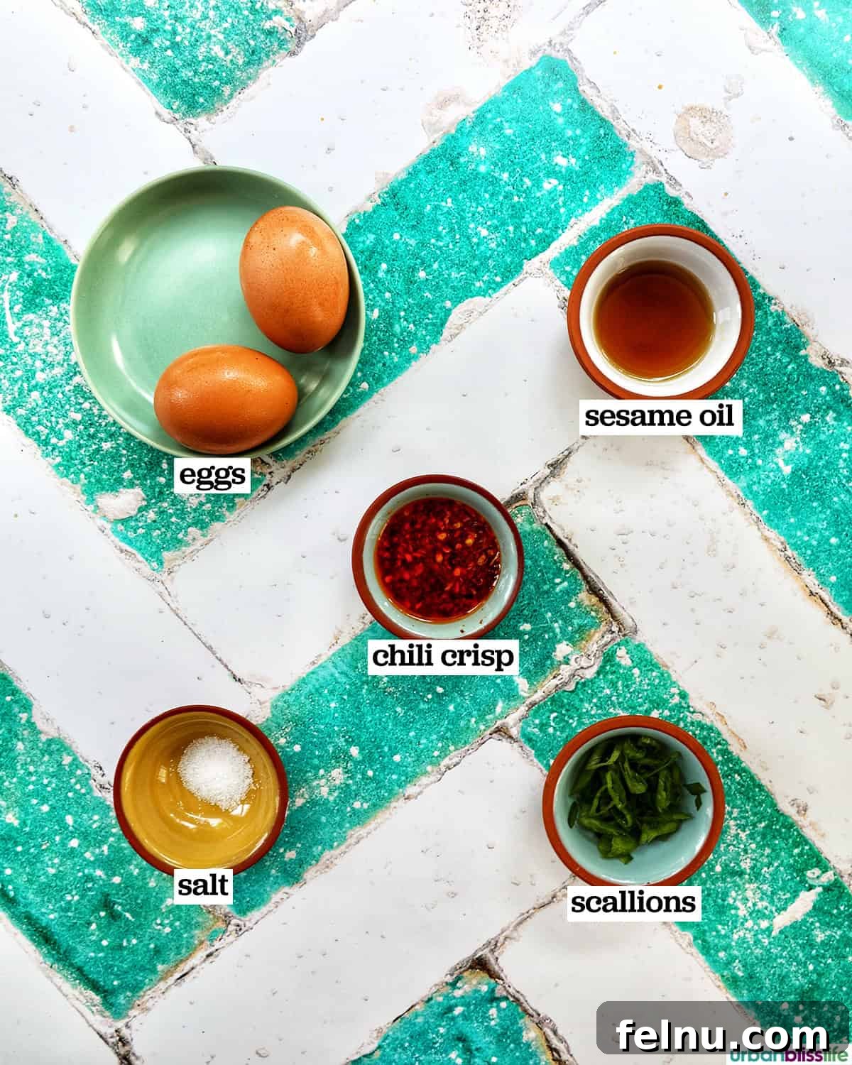 Golden Yolks, Fiery Crunch 5 Bowls displaying fresh eggs, chili crisp, sesame oil, and scallions, ready for making chili crisp eggs.