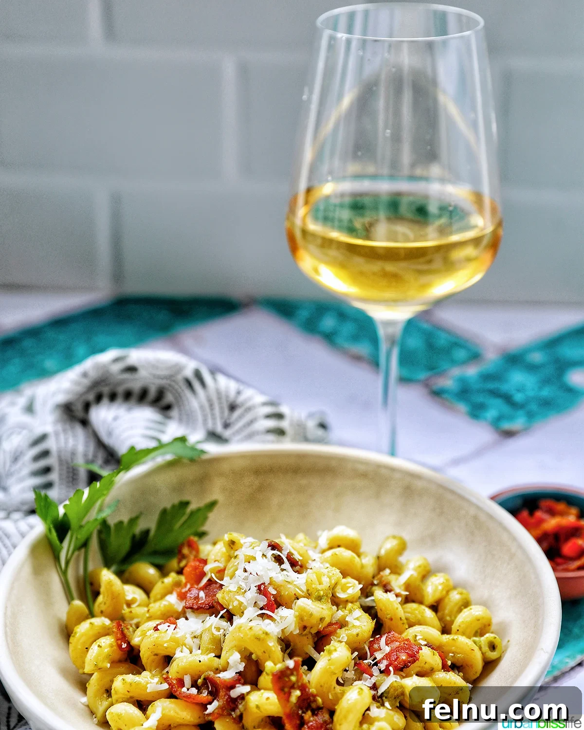 Cozy Fall Pasta Recipes 6 A bowl of savory bacon pesto pasta with a glass of refreshing white wine.