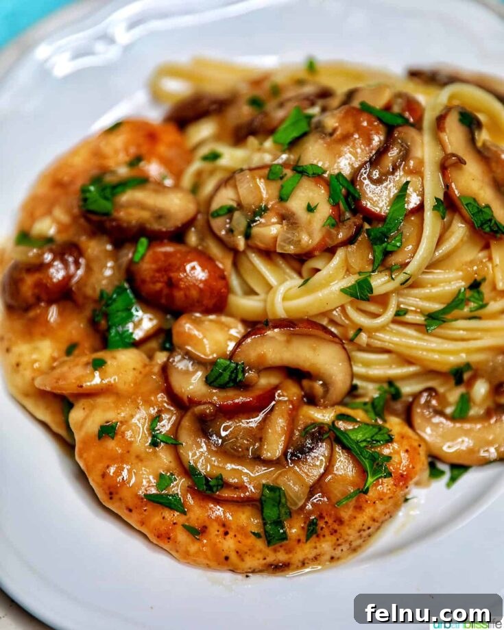 Tender chicken in a rich, savory mushroom and Marsala wine sauce, served over pasta for an elegant yet approachable meal.