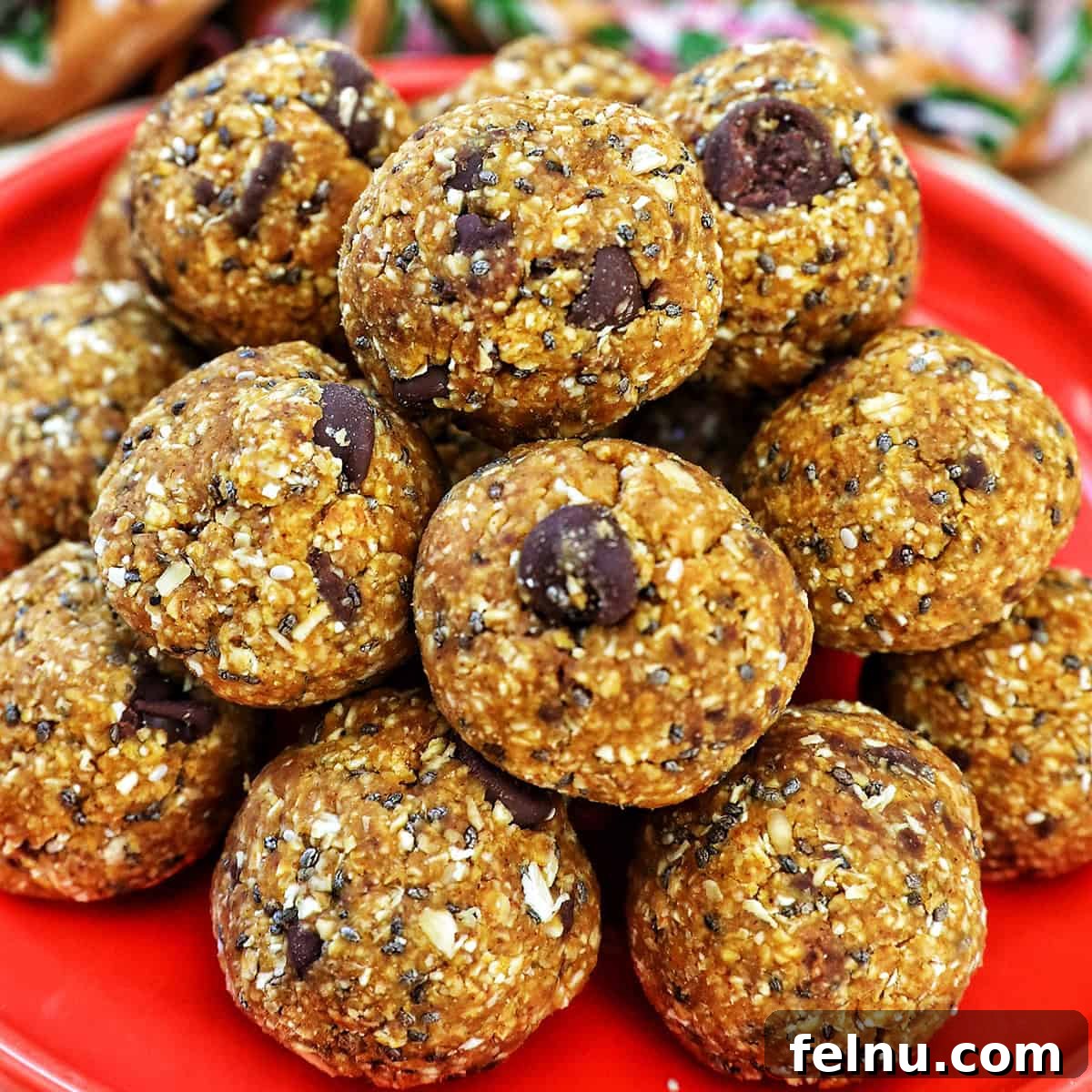 Stack of pumpkin protein balls on an orange plate.