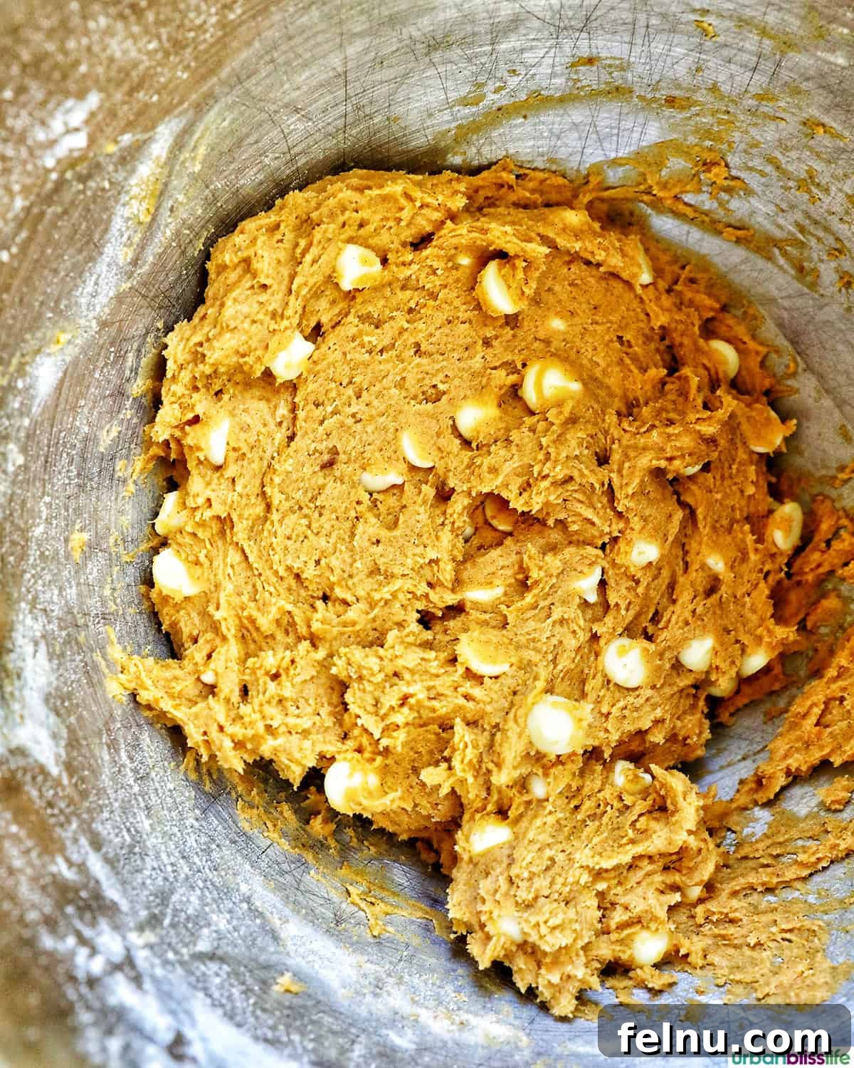 Pumpkin White Chocolate Chip Delights 12 White chocolate chip cookie batter in a bowl with white chocolate chips