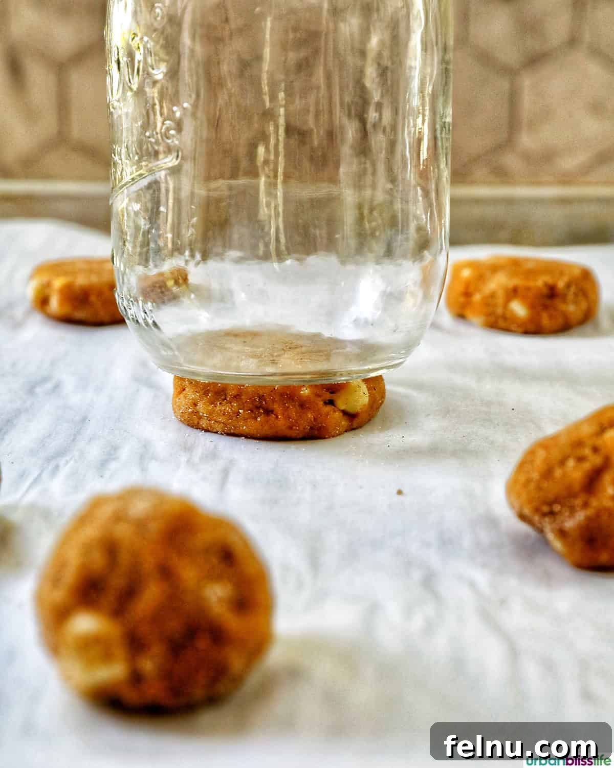 Pumpkin White Chocolate Chip Delights 16 Glass pressing down on pumpkin white chocolate chip cookie dough balls