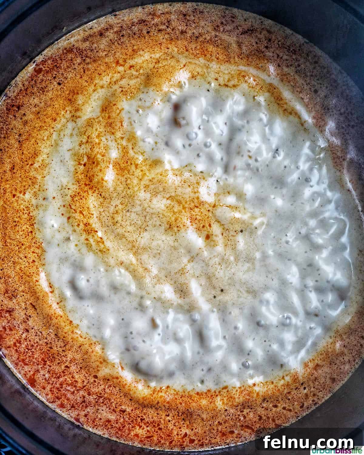 Aromatic Thai Red Curry Dumpling Soup 9 Creamy coconut milk being added to the simmering Thai red curry soup base.