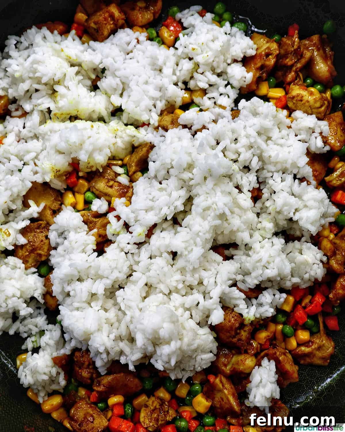 Curried Chicken Fried Rice 10 Stir-frying the curry chicken fried rice.
