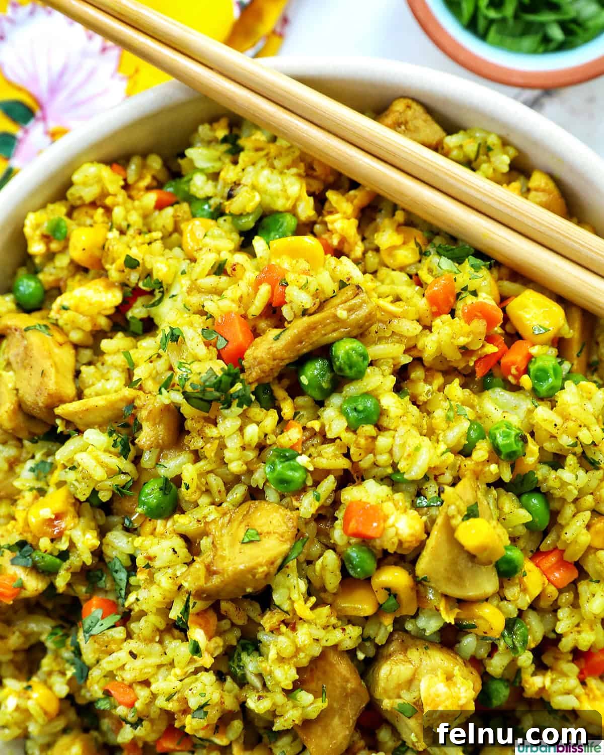 Curried Chicken Fried Rice 14 Curry Chicken Fried Rice served with chopsticks.