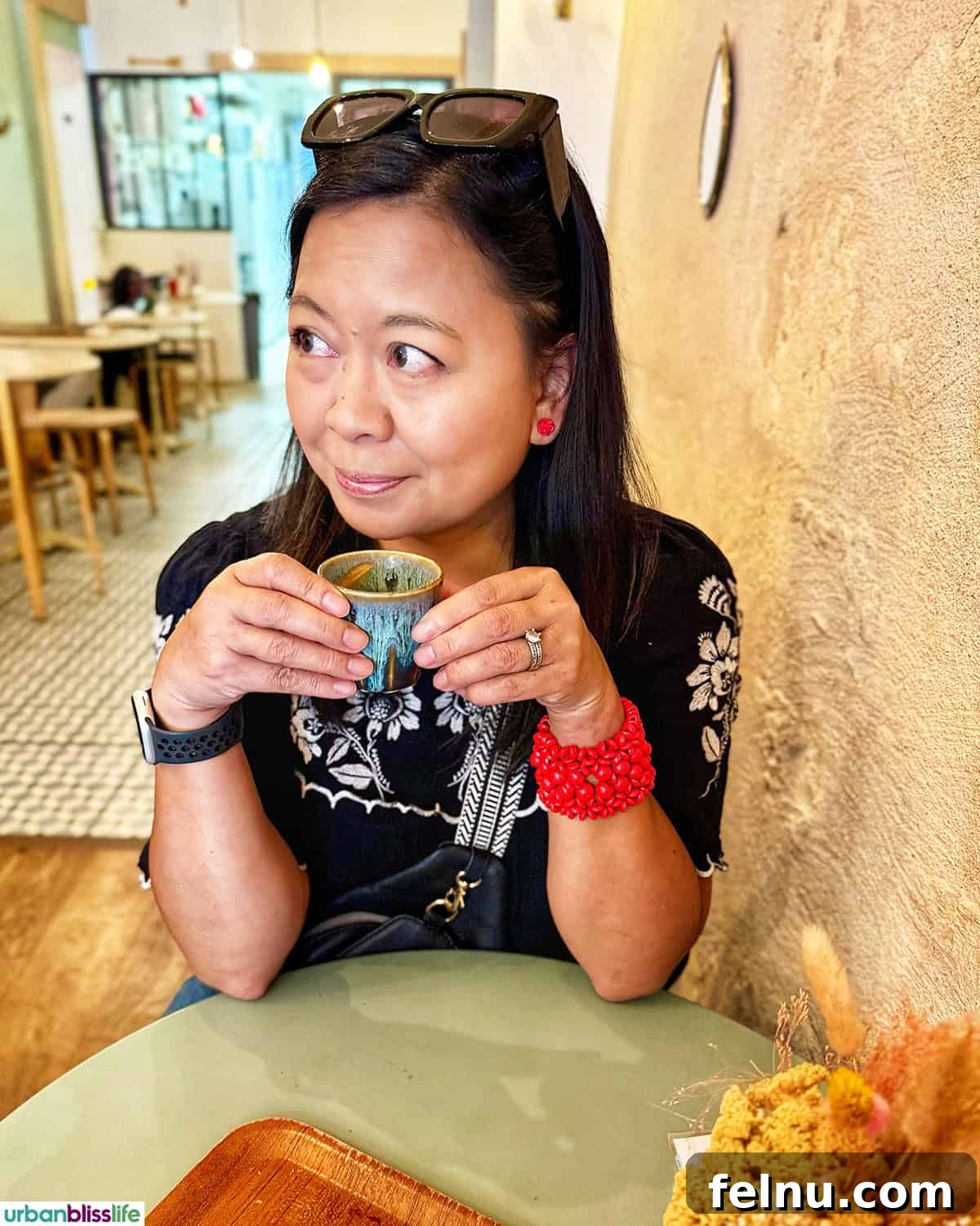Bordeaux: A Baker's Dozen Expedition 5 Marlynn smiling cheerfully in front of boulangerie Michel MaBelle in Bordeaux, France, holding a pastry and ready to enjoy the local delights.