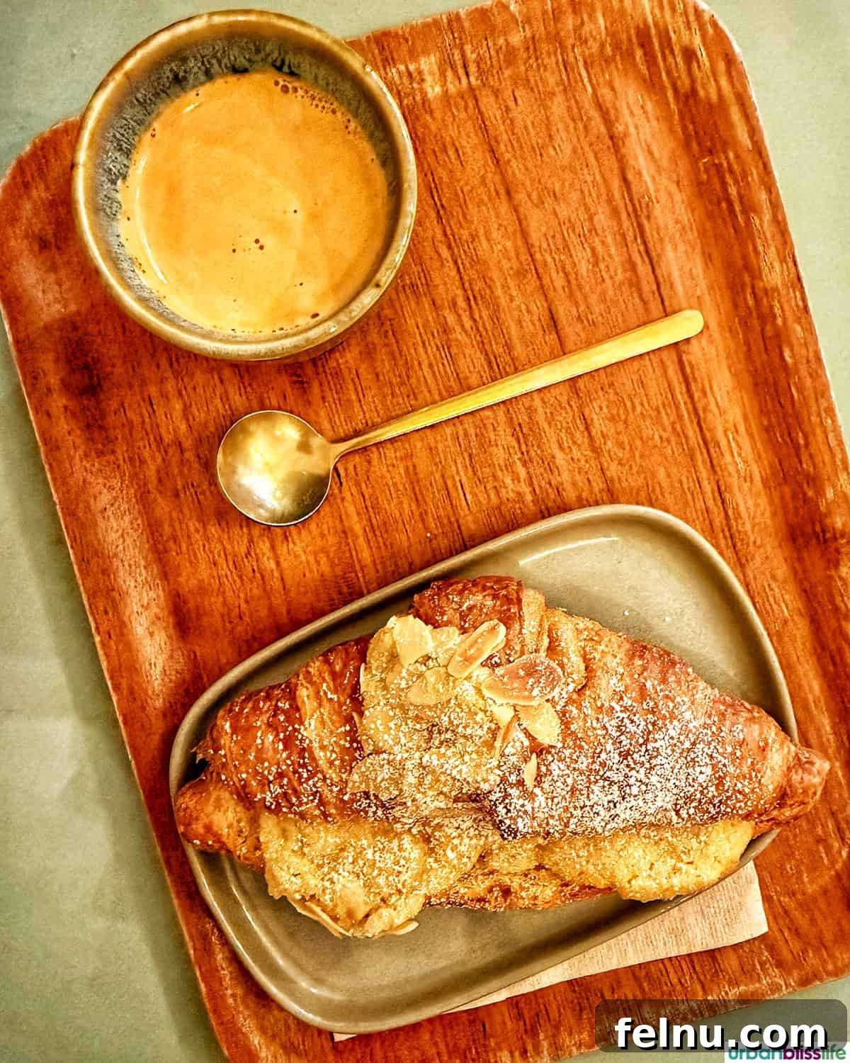 Bordeaux: A Baker's Dozen Expedition 9 A perfectly brewed espresso accompanied by a flaky almond croissant, served on a stylish tray at Cafe Michel MaBelle in Bordeaux, France.