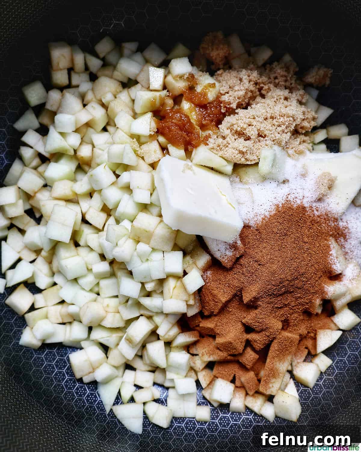 Diced green apples, butter, and cinnamon cooking in a pot for filling.