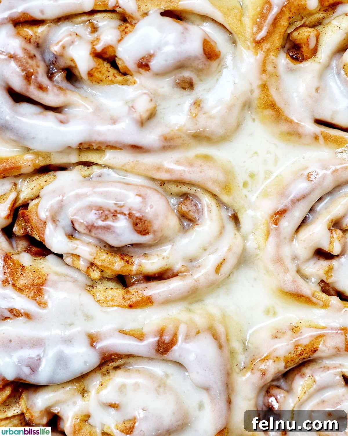 Close-up of fluffy Apple Pie Cinnamon Rolls with icing.