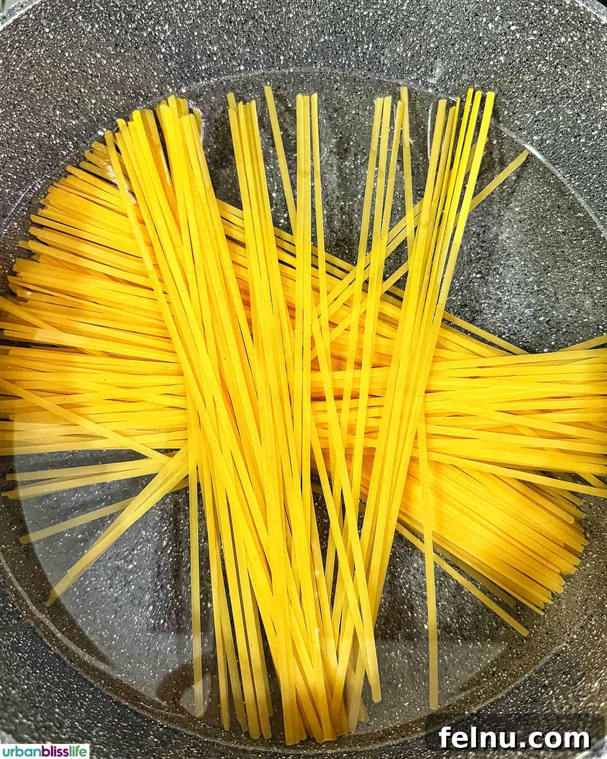 Tuscan Sausage Pasta Delight 6 Pasta cooking in water