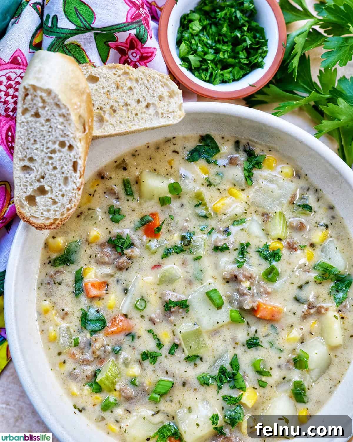 Smoky Sausage and Sweet Corn Chowder 2 A steaming bowl of creamy corn and sausage chowder, garnished with fresh herbs, served with crusty bread.