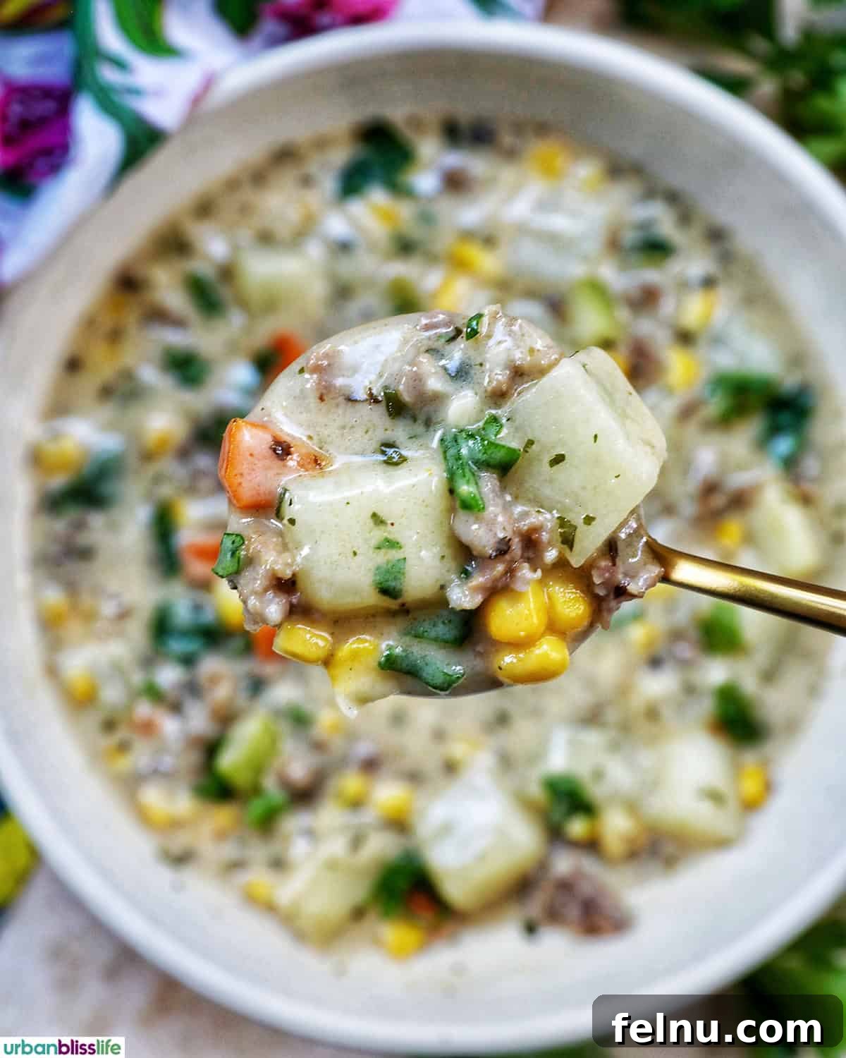 Smoky Sausage and Sweet Corn Chowder 15 A spoonful of creamy corn and sausage chowder, showing the texture and ingredients.