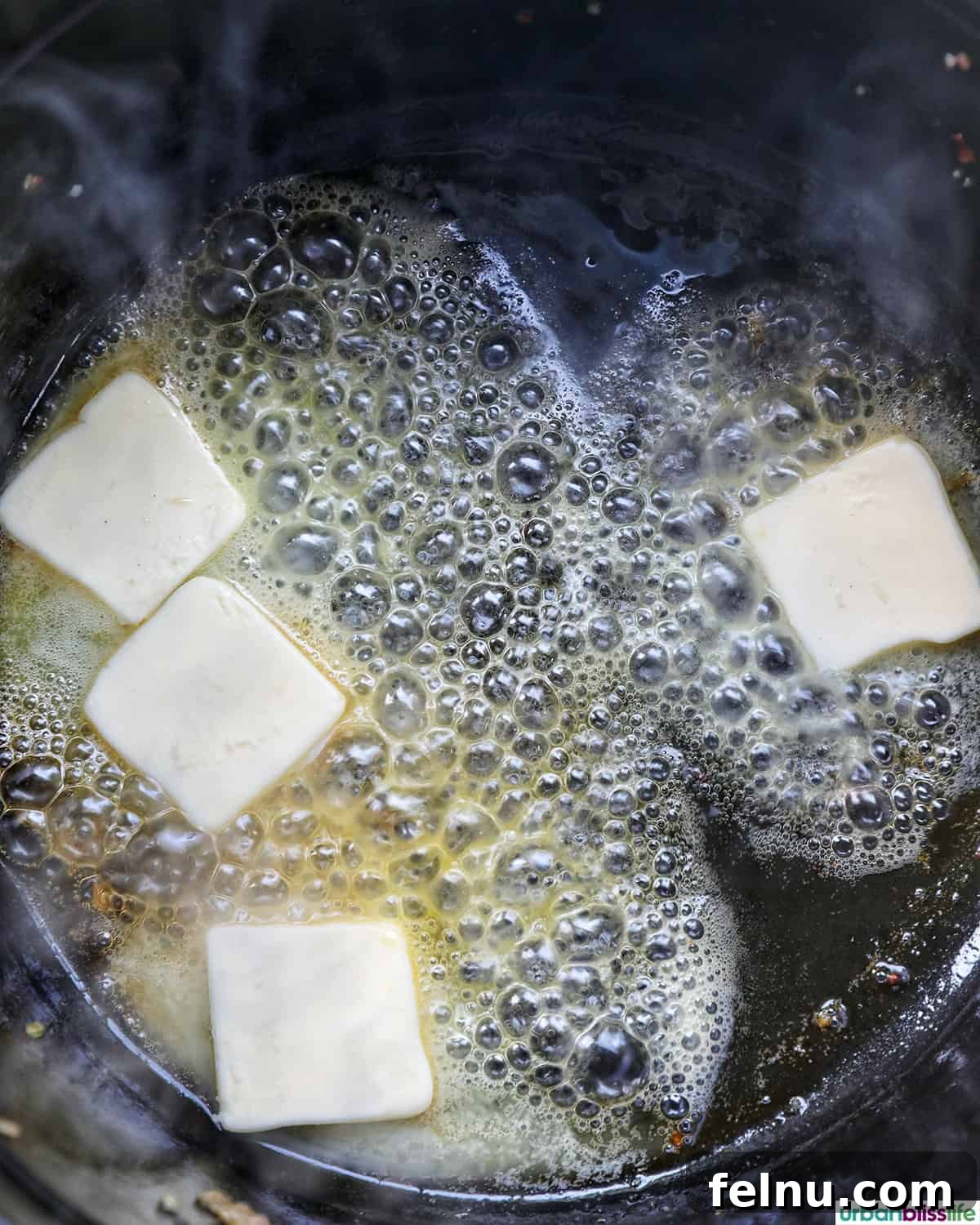 Smoky Sausage and Sweet Corn Chowder 7 Unsalted butter melting in a Dutch oven after sausage has been removed.