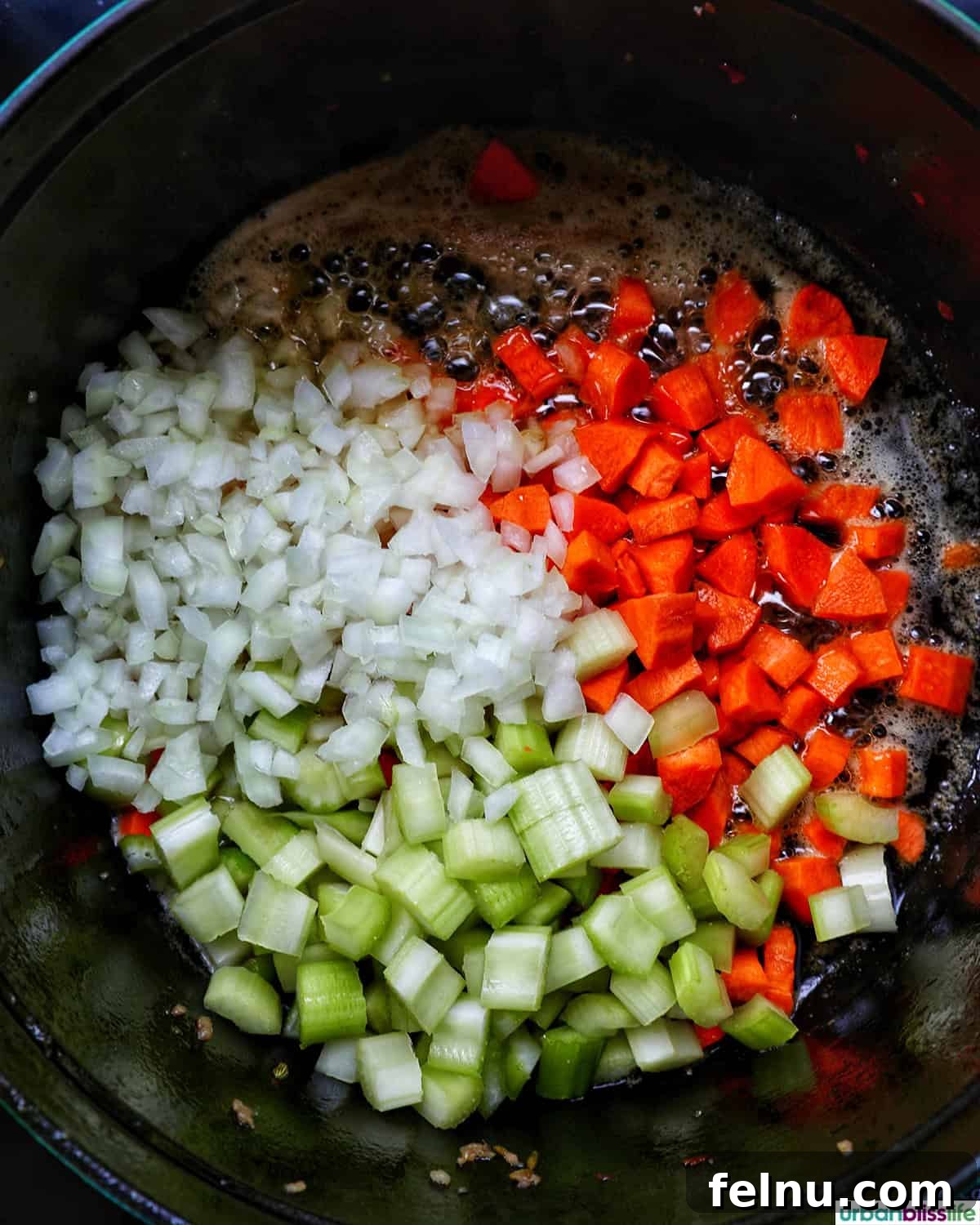 Smoky Sausage and Sweet Corn Chowder 8 Diced carrots, celery, and onions sautéing in melted butter in a Dutch oven.