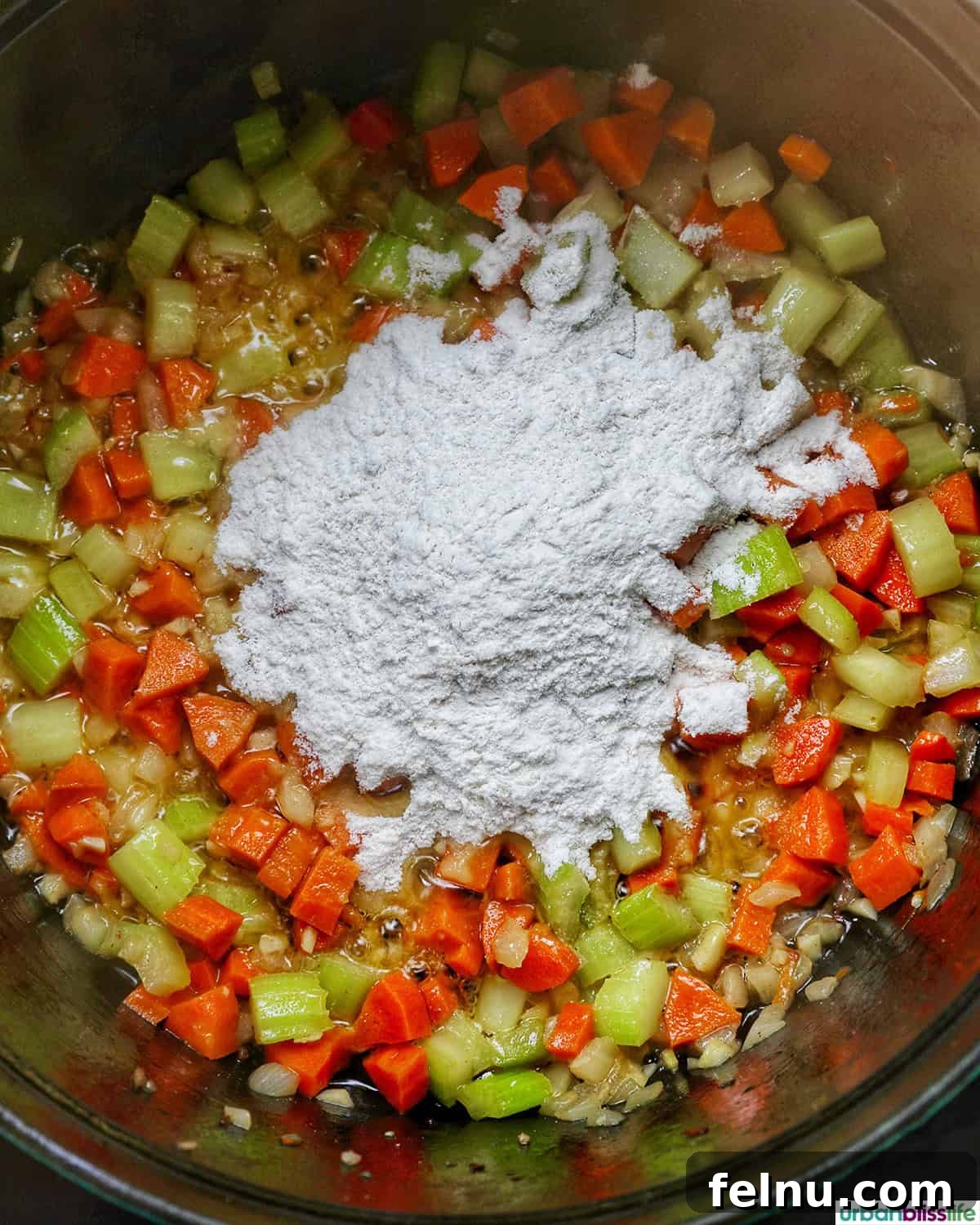 Smoky Sausage and Sweet Corn Chowder 10 All-purpose flour sprinkled over vegetables in a pot, ready to create a roux.