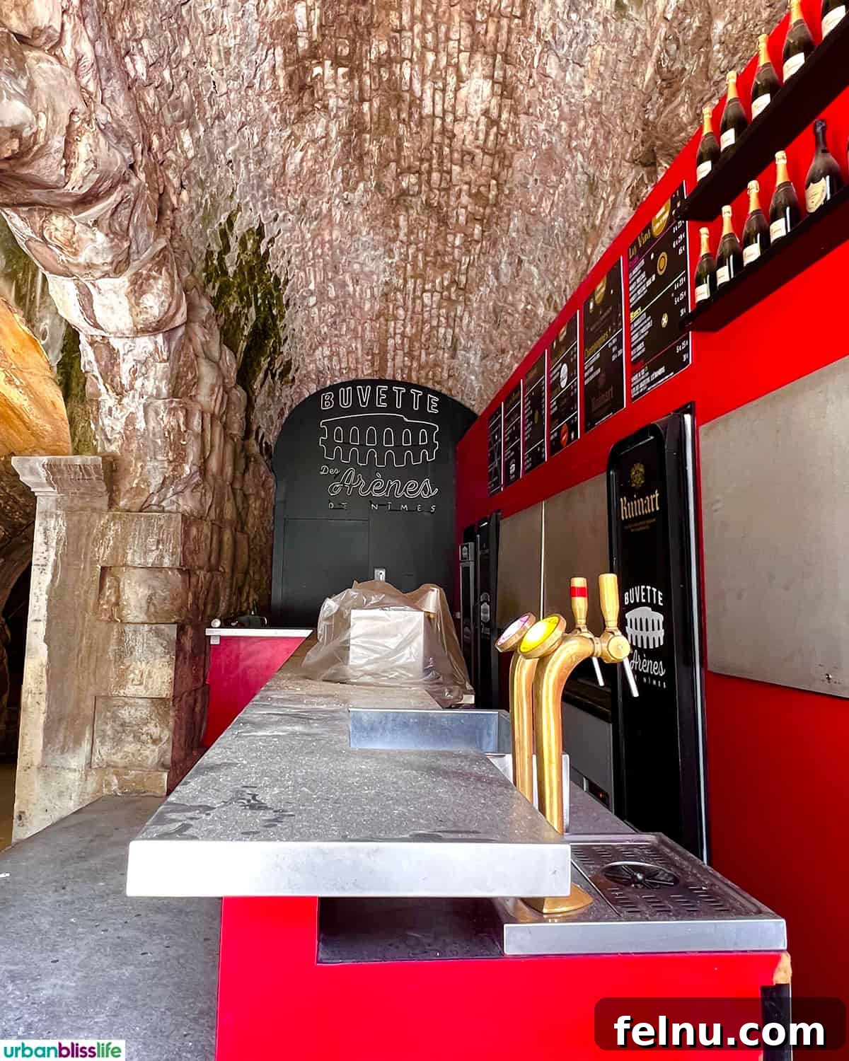 Montpellier Magic: Your Guide to a French Gem 25 A modern Champagne bar setup inside the historic Nîmes arena, offering a unique blend of ancient and contemporary.