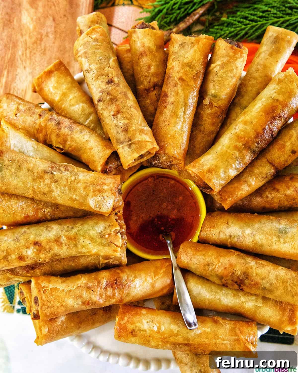 Friendsgiving Feast: A Celebration of Gratitude and Good Food 6 Delicious Filipino lumpia served with sweet chili sauce, a perfect appetizer for Friendsgiving.