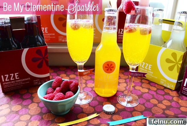 Clementine Love Sparkler 3 IZZE mixed drink recipe featuring Clementine and sparkling wine, garnished with fresh raspberries.