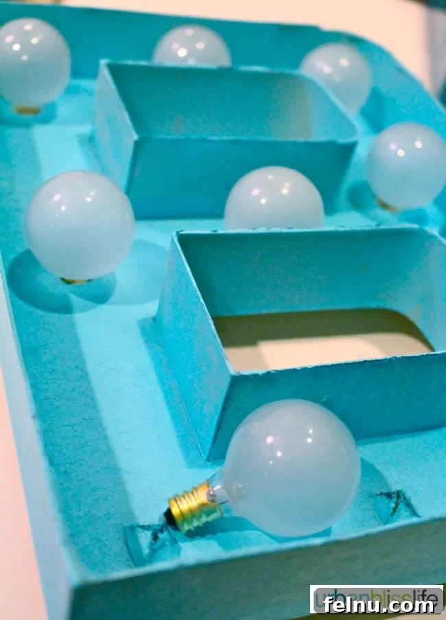 Simple DIY Illuminated Signage Guide 11 Inserting the light bulbs into the paper mache letters