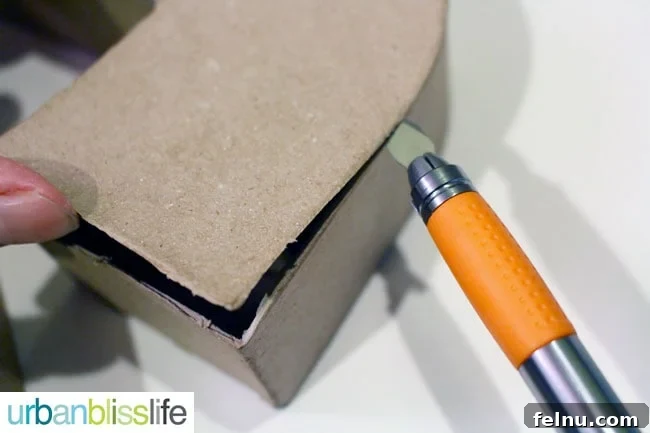 Simple DIY Illuminated Signage Guide 4 Using an X-Acto knife to carefully cut out the front of a paper mache letter