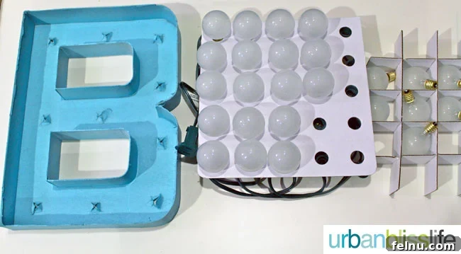 Simple DIY Illuminated Signage Guide 10 Unscrewing the light bulbs from the string and organizing them in the cardboard separator