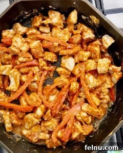Creamy Thai Peanut Delight 9 pork and red peppers in skillet