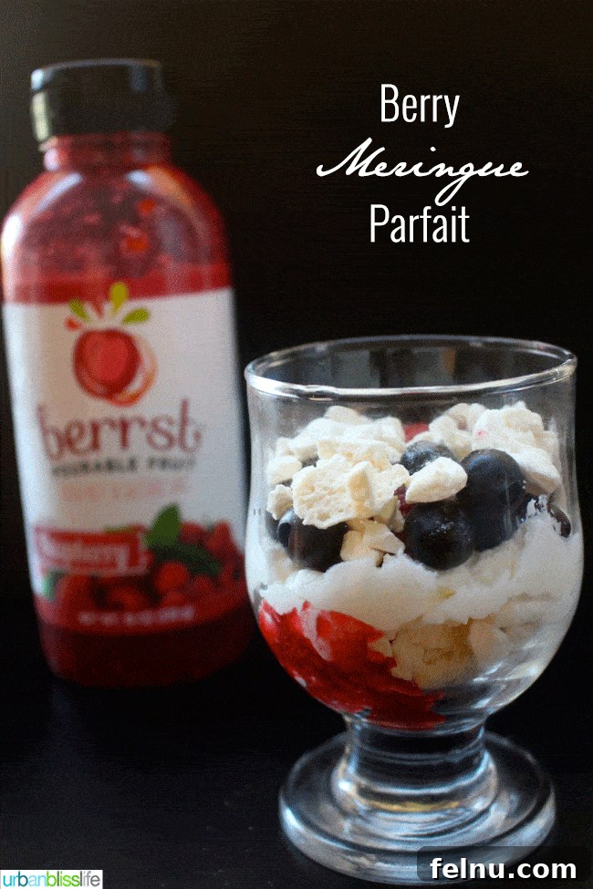 Adding another layer of meringue and berry puree.
