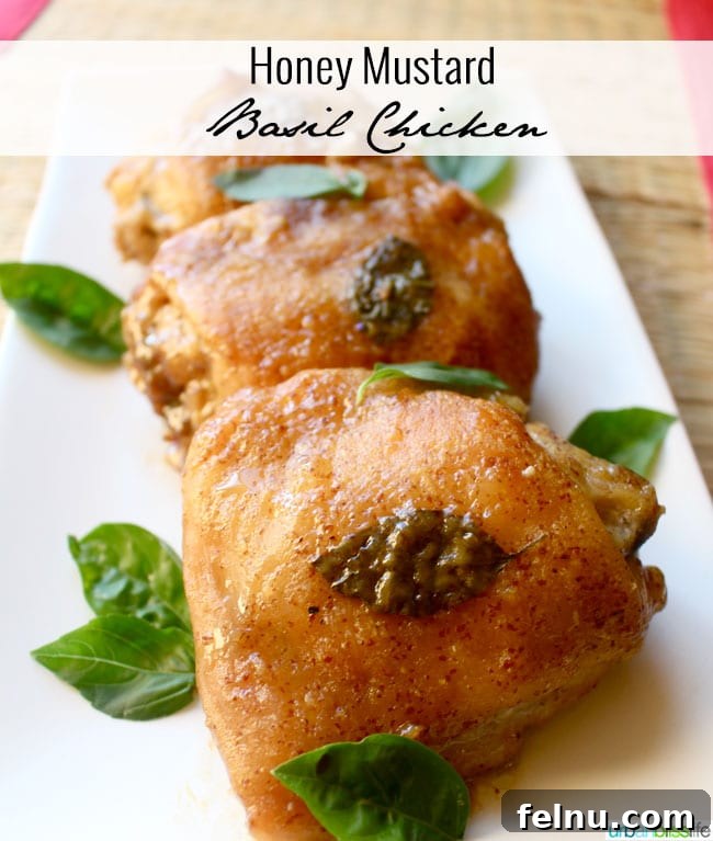 Glazed Honey Mustard Chicken Thighs with Bright Basil 2 Golden brown honey mustard chicken thighs garnished with fresh basil leaves on a white plate, ready to serve.