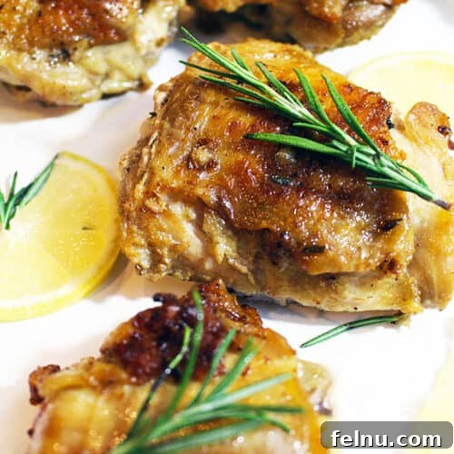 Glazed Honey Mustard Chicken Thighs with Bright Basil 4 Cast iron skillet chicken with rosemary sprig and lemon slices.