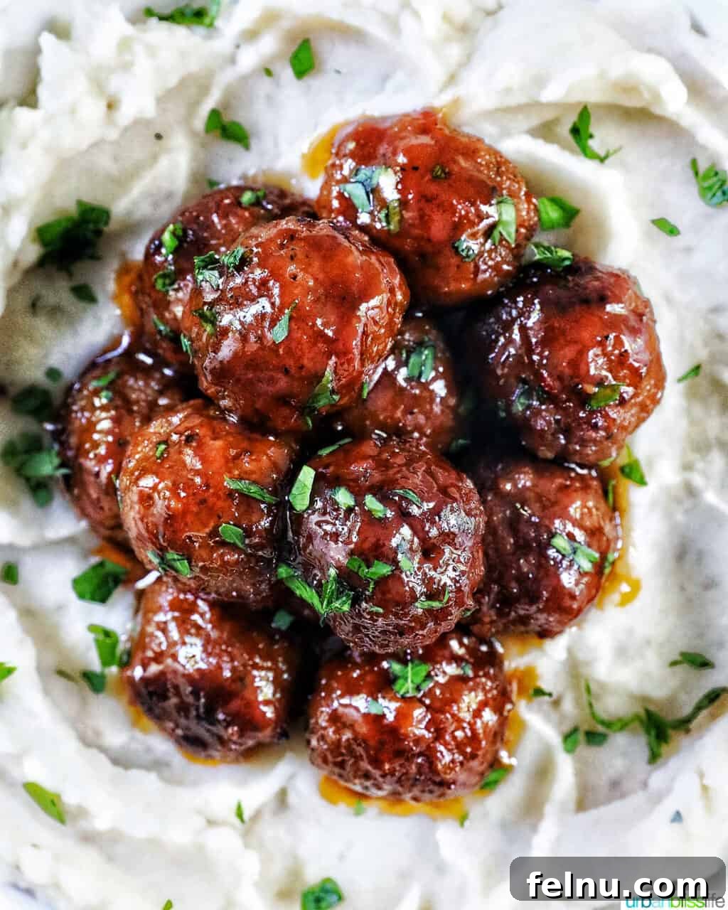 Honey Bourbon Glazed Meatballs (Slow Cooker Recipe) 13 Honey bourbon meatballs over mashed potatoes with parsley.