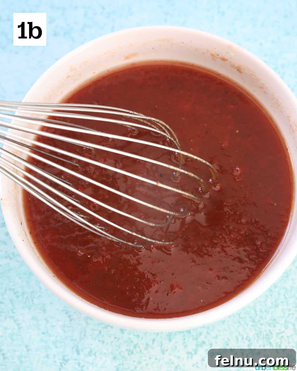 Honey Bourbon Glazed Meatballs (Slow Cooker Recipe) 6 Honey bourbon sauce whisked together in a white bowl.