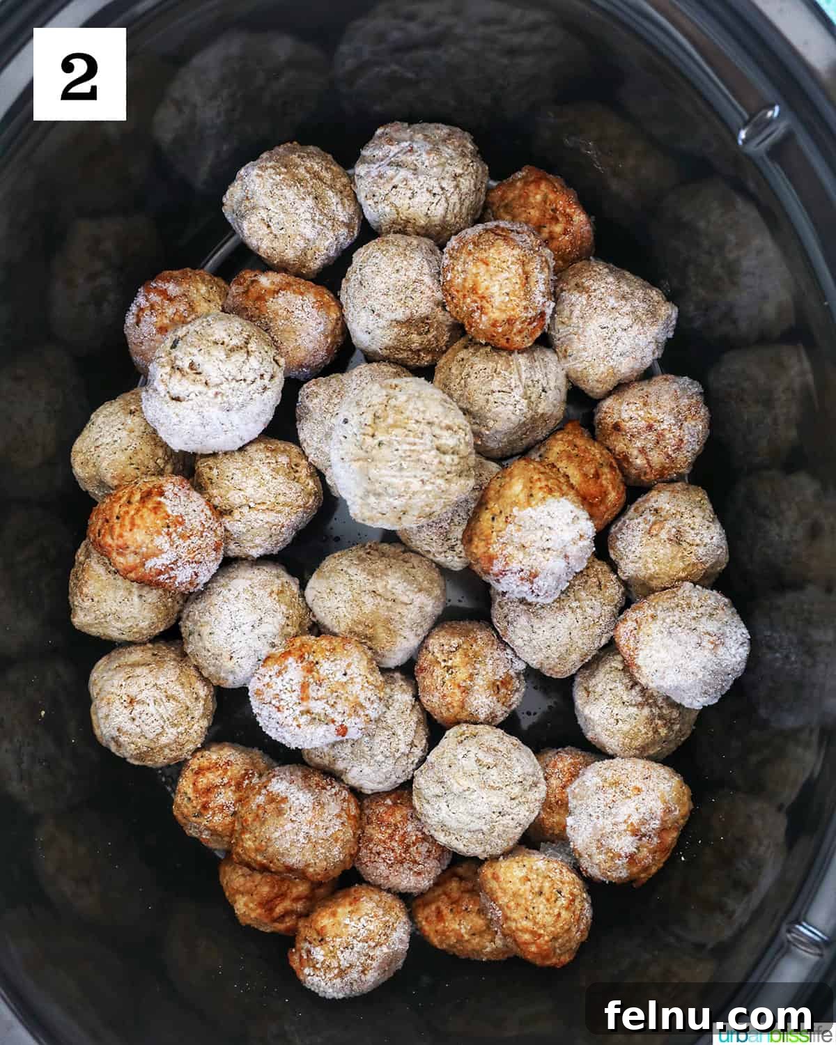 Honey Bourbon Glazed Meatballs (Slow Cooker Recipe) 7 Frozen meatballs in a slow cooker.