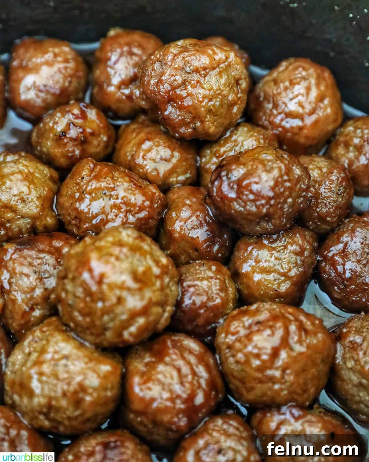 Honey Bourbon Glazed Meatballs (Slow Cooker Recipe) 10 Cooked honey bourbon meatballs in a slow cooker.