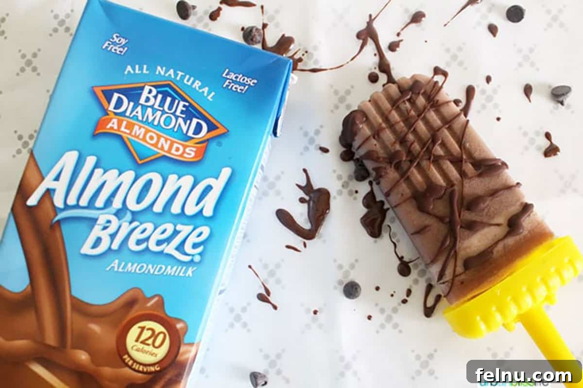 Plant-Based Chocolate Peanut Butter Fudge Pops with Chocolate Chunks 4 A bottle of Almond Breeze Chocolate Almondmilk alongside a finished chocolate peanut butter popsicle.