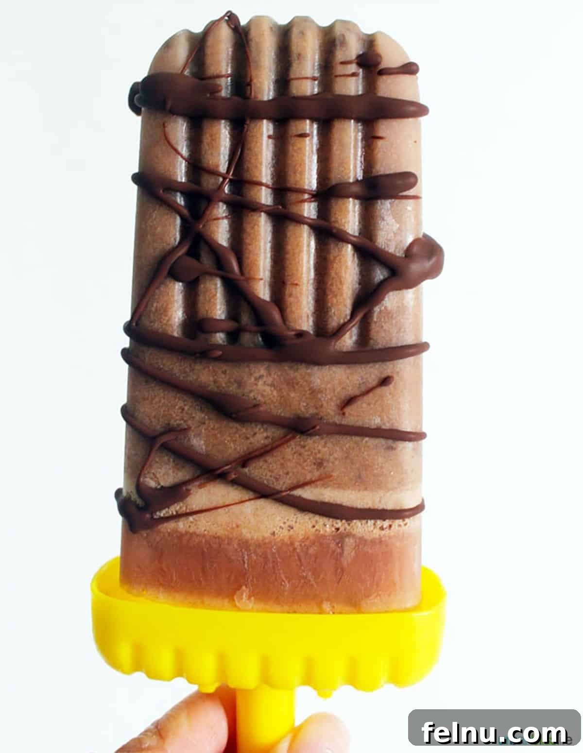 Plant-Based Chocolate Peanut Butter Fudge Pops with Chocolate Chunks 6 A single dairy-free, vegan chocolate peanut butter popsicle, perfectly formed and ready to eat.