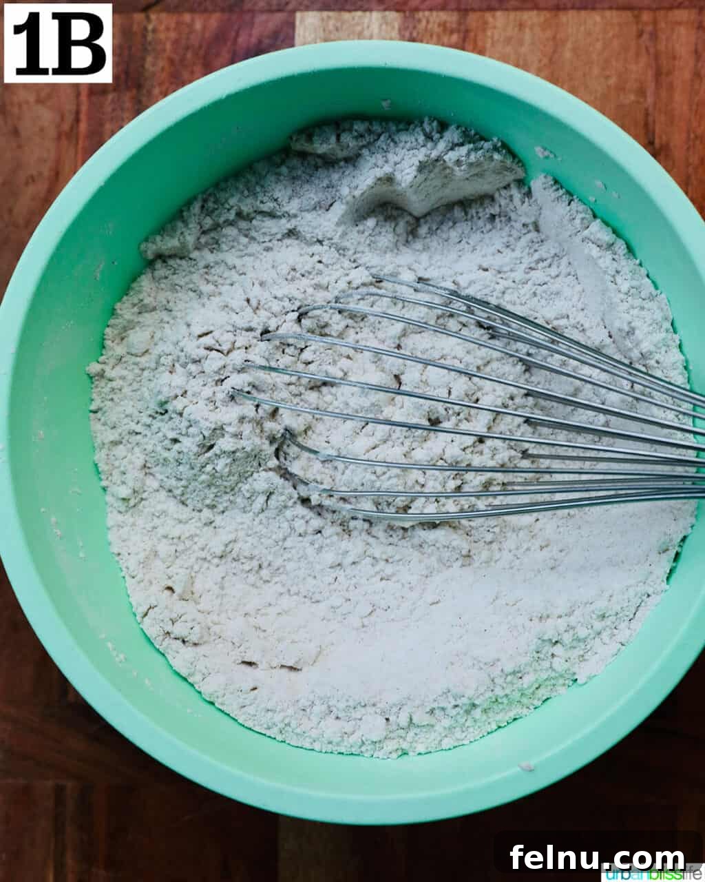 Crispy Cinnamon Apple Fritters 7 Whisking together dry ingredients for apple fritter donuts in a bowl.