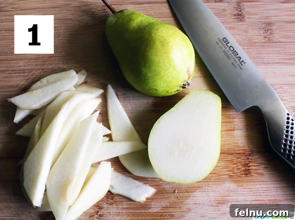 Golden Pear Bites 3 Fresh Bartlett pears, one whole and one expertly sliced into thin, elegant pieces, laid out on a cutting board next to a chef's knife, ready for tartlet preparation.