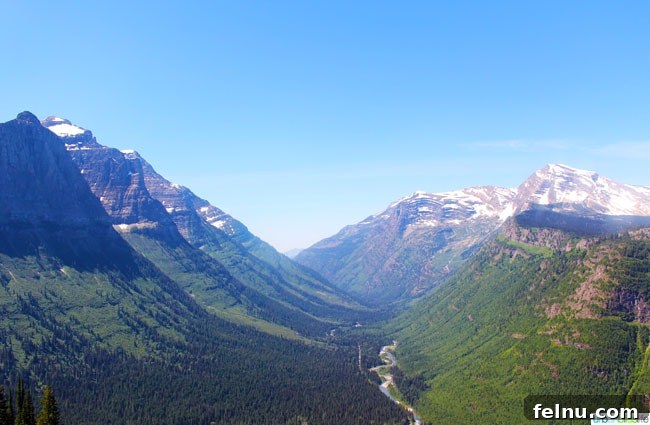 Exploring the Crown of the Continent 9 Going-to-the-Sun Road hugging a cliffside, offering panoramic views of valleys and distant mountains