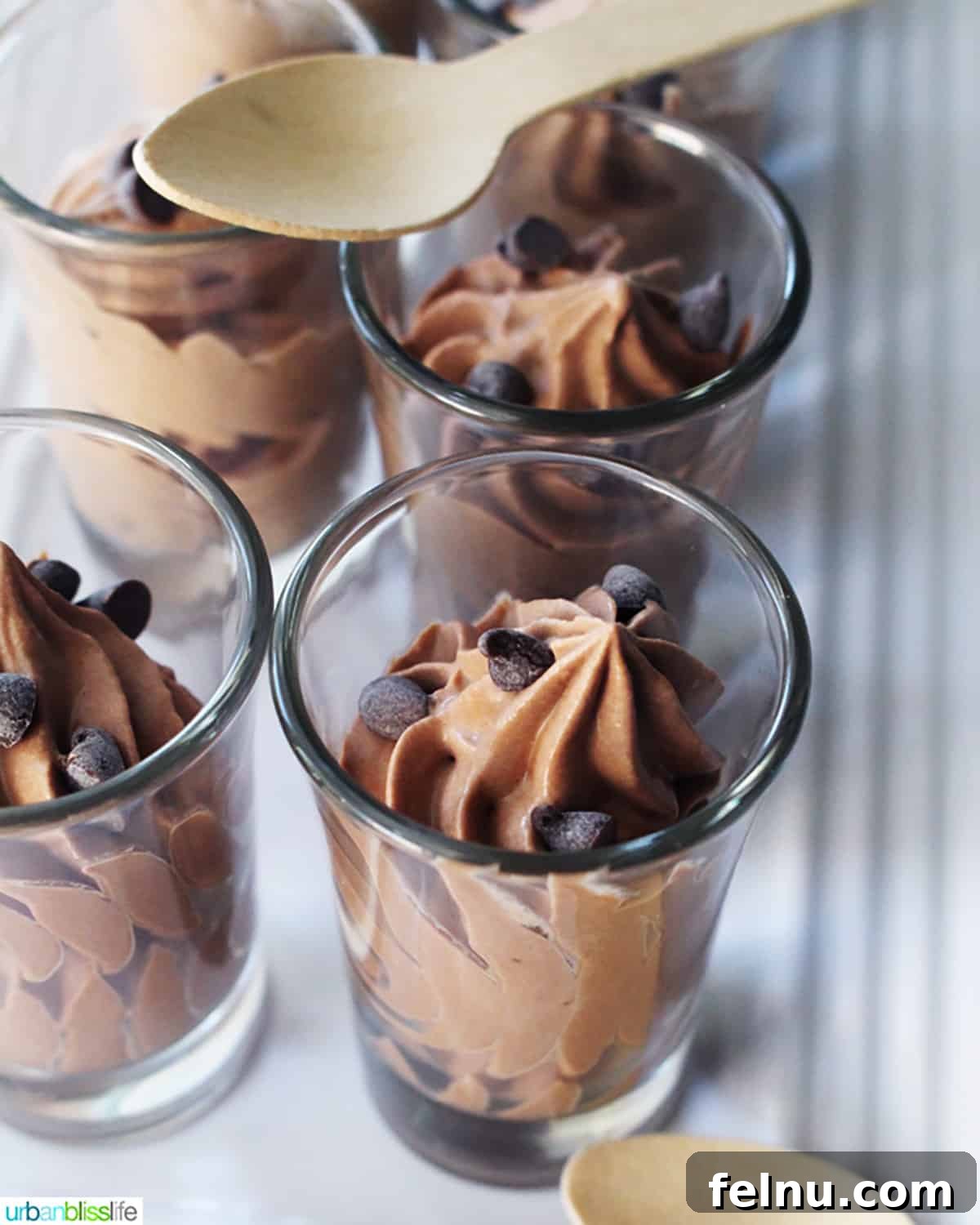 Dairy-free chocolate mousse in shot glasses with wooden spoons