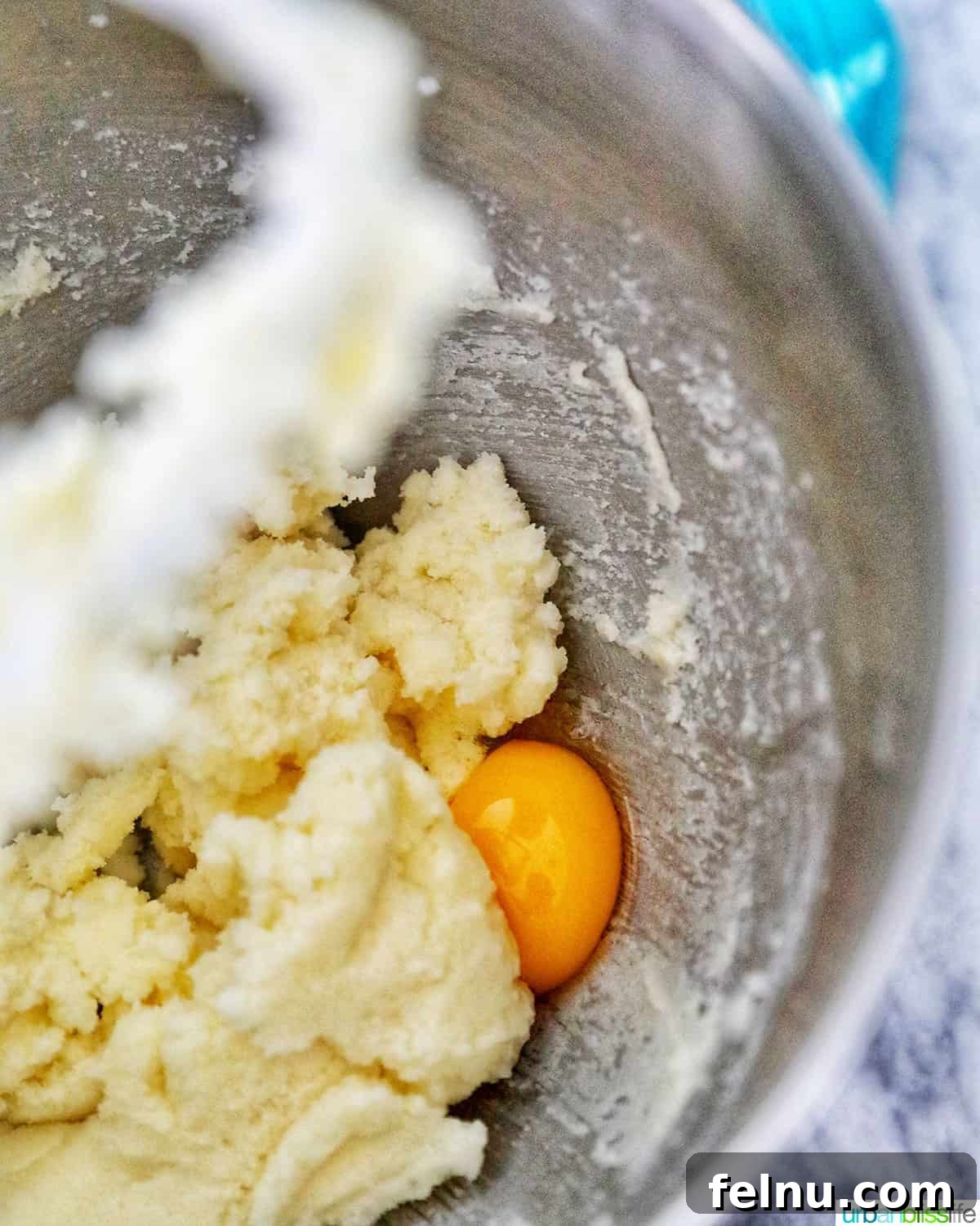 Cinnamon Swirl Delights 5 Adding eggs to batter in a stand mixer