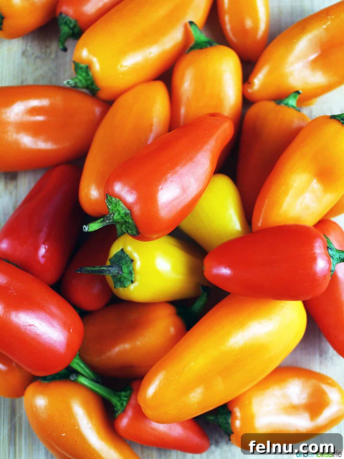 Sweet and Spicy Chili Dip 4 A vibrant array of red, orange, and yellow bell peppers, showcasing the foundational ingredients for crafting flavorful sweet chili dipping sauce.