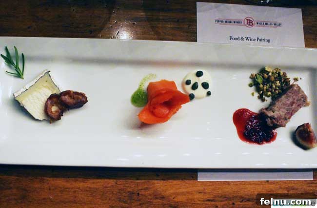 Walla Walla's Pepper Bridge Winery 12 A gourmet charcuterie plate with various cheeses, cured meats, and fresh garnishes, presented beautifully for a wine pairing.