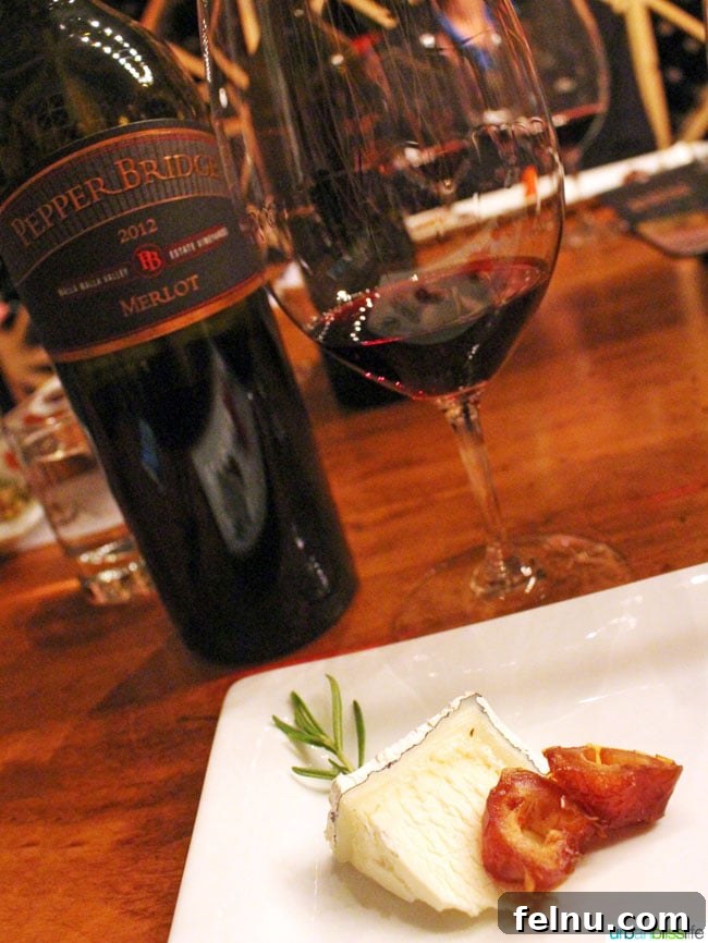 Walla Walla's Pepper Bridge Winery 13 A glass of Pepper Bridge Merlot paired with Humboldt Fog cheese, dates, and a rosemary sprig, showcasing a perfect culinary match.