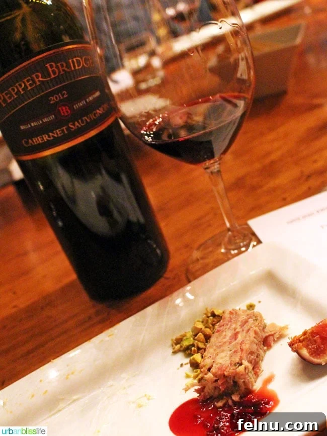 Walla Walla's Pepper Bridge Winery 15 A glass of Pepper Bridge Cabernet Sauvignon paired with Olympia Provisions Pork Rillette, blackberry compote, and fresh fig, demonstrating a gourmet food and wine synergy.