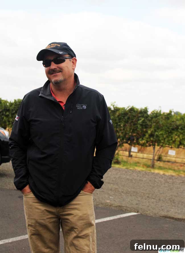 Walla Walla's Pepper Bridge Winery 4 Jean-François Pellet, winemaker and partner at Pepper Bridge Winery, shown with a thoughtful expression, embodying his passion for winemaking.