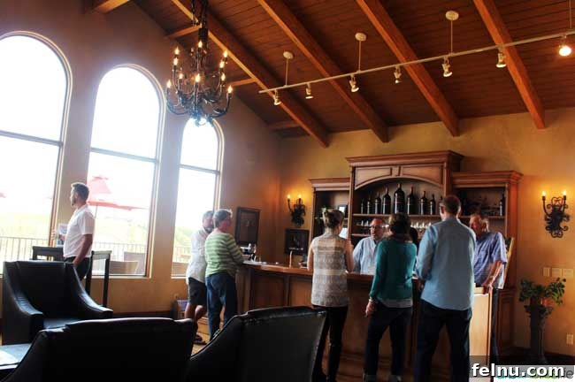 Walla Walla's Pepper Bridge Winery 5 The elegant tasting room at Pepper Bridge Winery, featuring Tuscan-yellow walls, warm wood, and comfortable seating, inviting guests to relax.